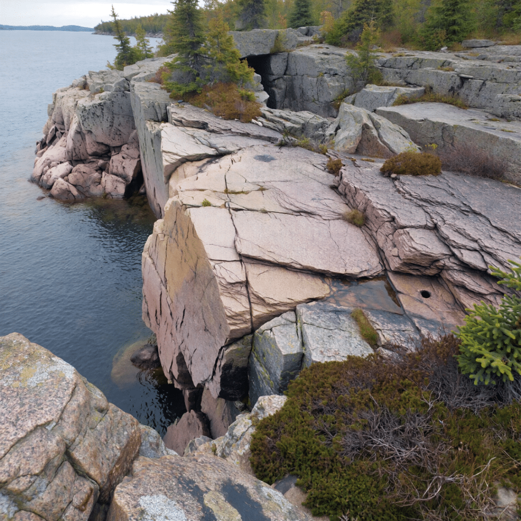 Rocky bedrock terrain on waterfront land in Kingston Ontario showing site conditions and excavation requirements for cottage construction