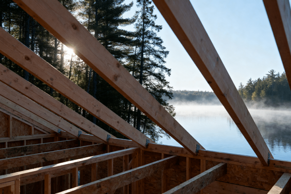 Custom lakefront cottage under construction in Kawartha Lakes showing the framing stage of a home build, illustrating how long it takes to build a cottage in Kawartha Lakes.